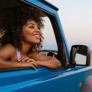 Image of Cheerful African American Woman Smiling While Travelling in Car