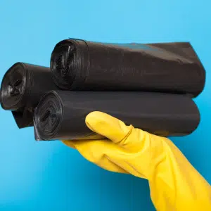 Clean black disposable trash bags, garbage clipping container